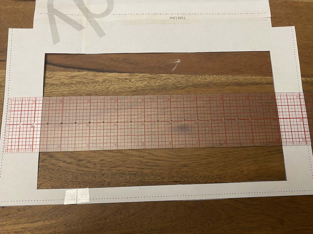 A paper pattern is measured with a ruler